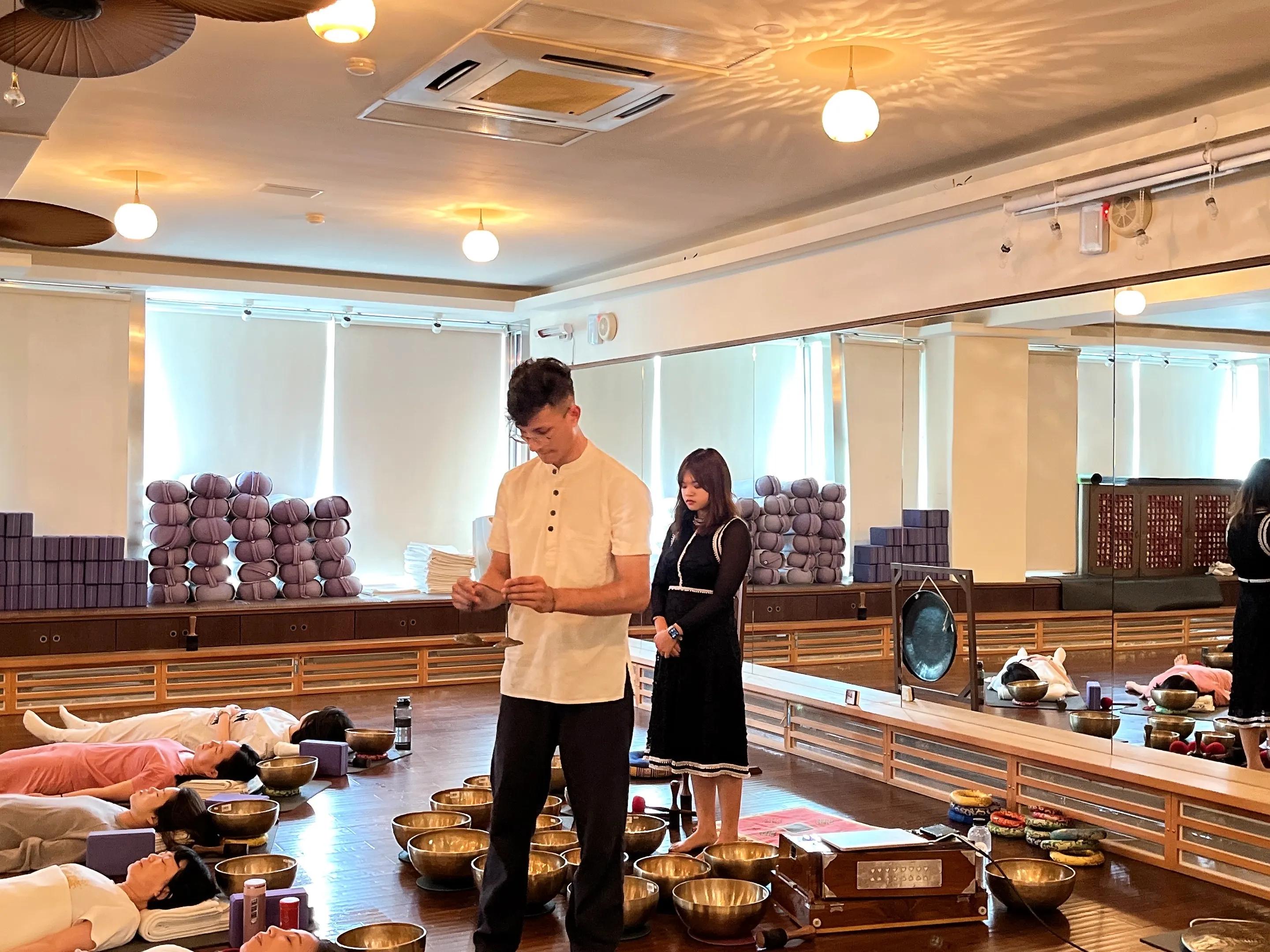 A sound healing session in progress with an instructor and participants